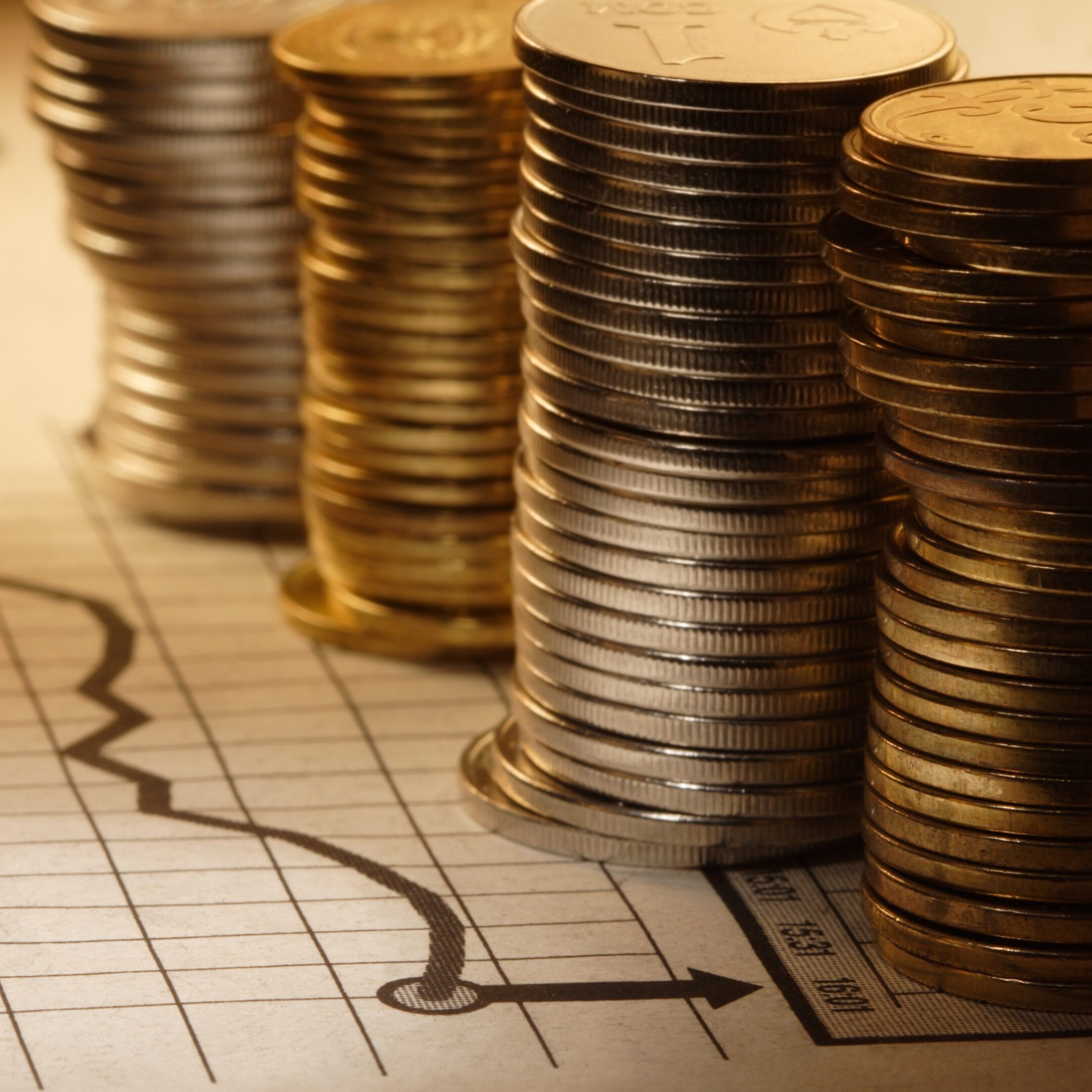Stacks of coins on financial graph